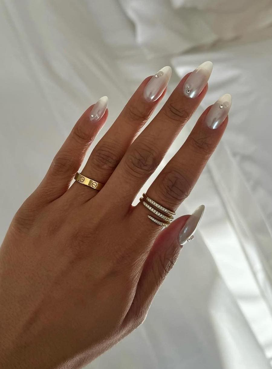 White chrome nails with pearls and gems