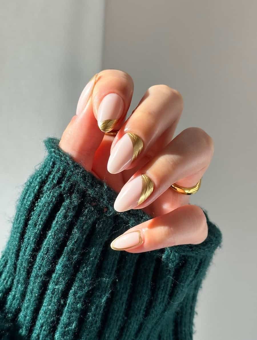 nude nails with asymmetrical gold accents