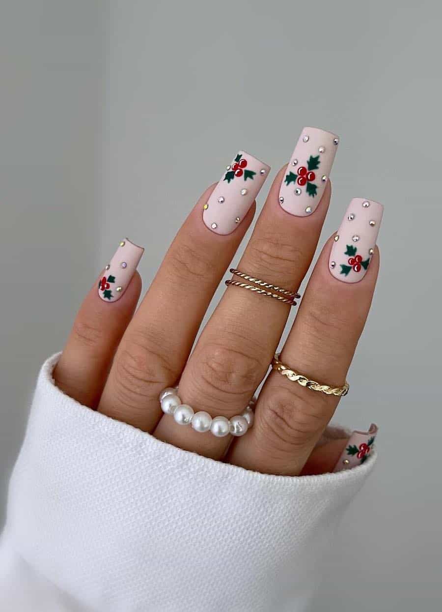 soft pink nails with mistletoe art and gem accents