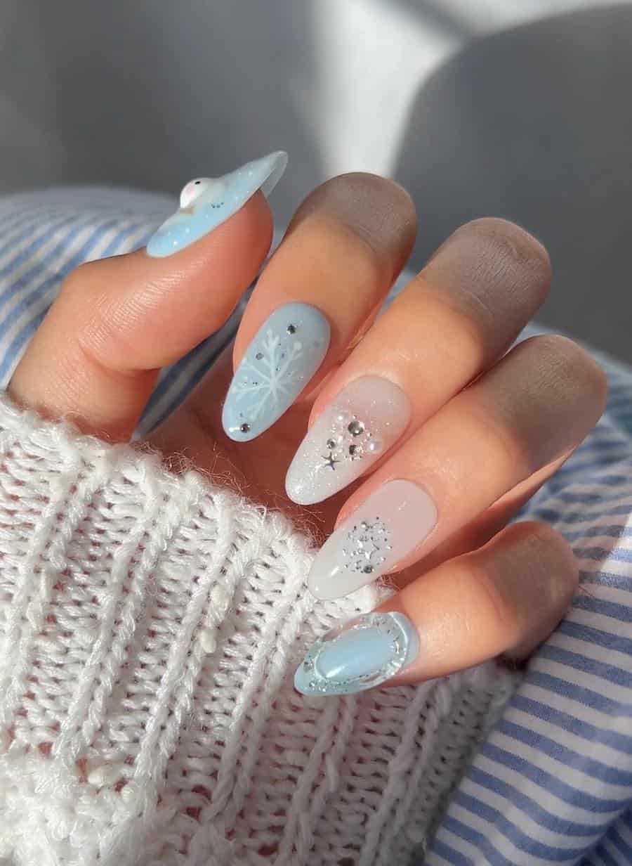 icy blue and milky white nails with gems, pearls, and snowflake art