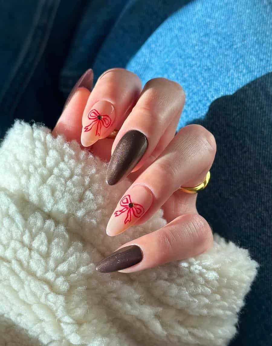 shimmering brown and nude nails with red bow accents