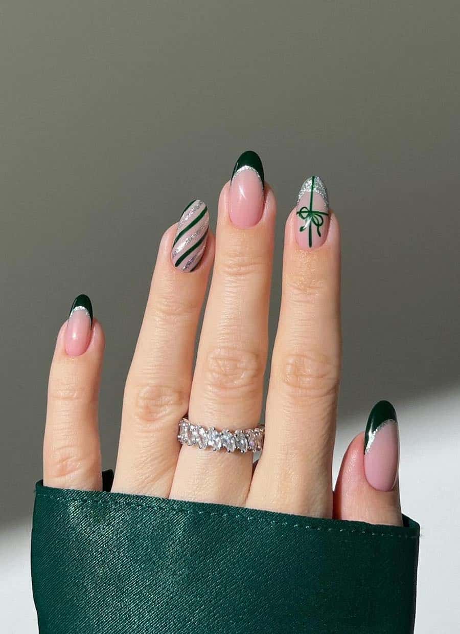 nude and green nails with silver glitter accents and holiday-inspired art