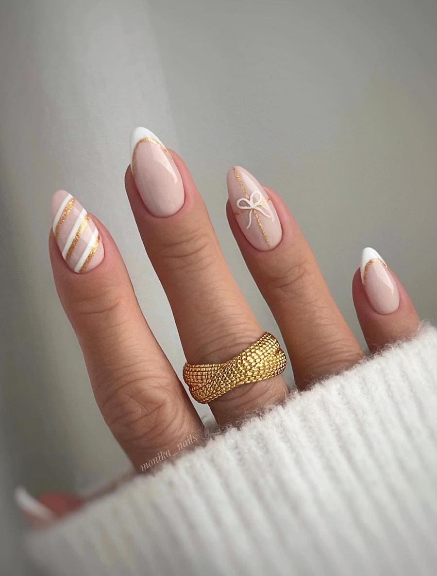nude nails with white and gold glitter christmas art