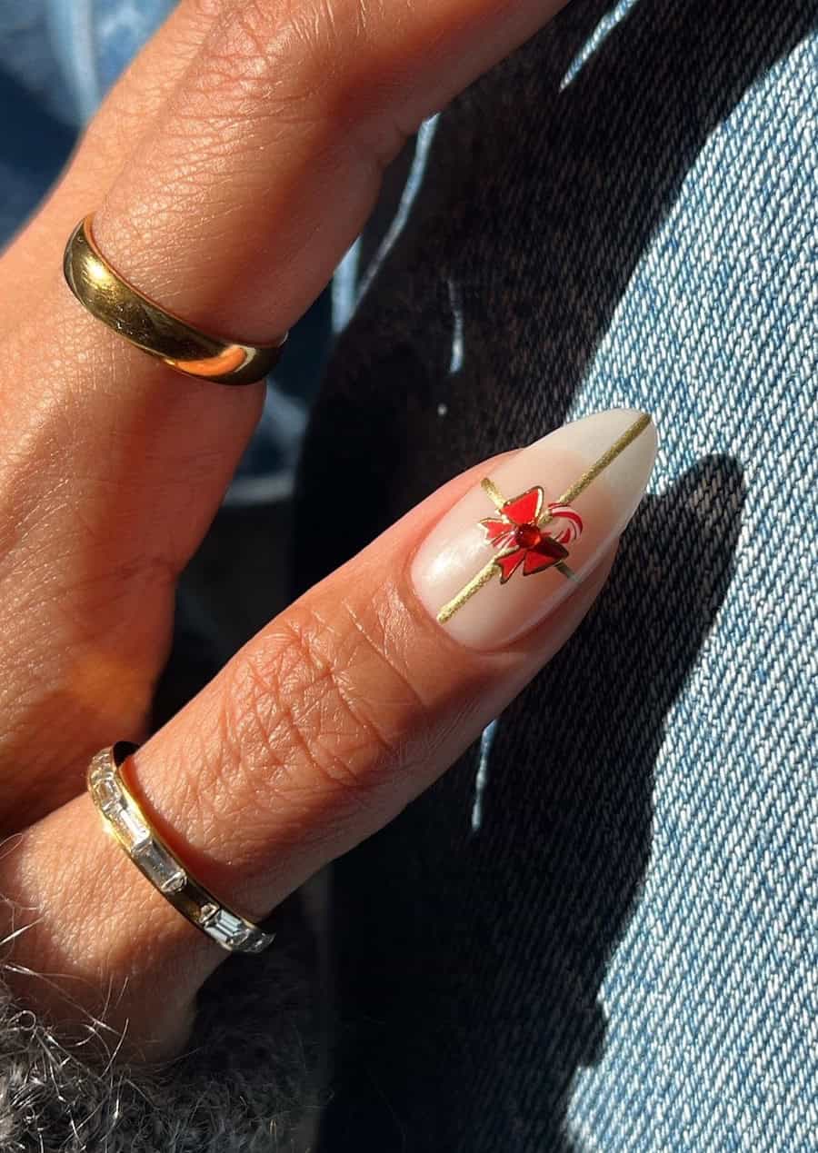 nude nails with gold present style ribbons, red bows, and candy canes