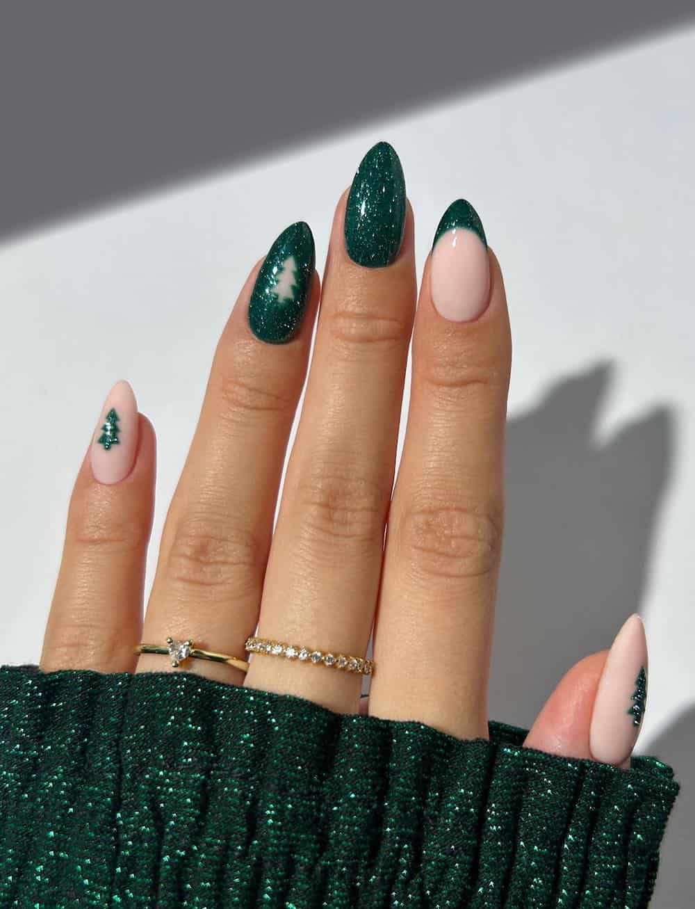 nude and glittering green nails with pine tree accent art