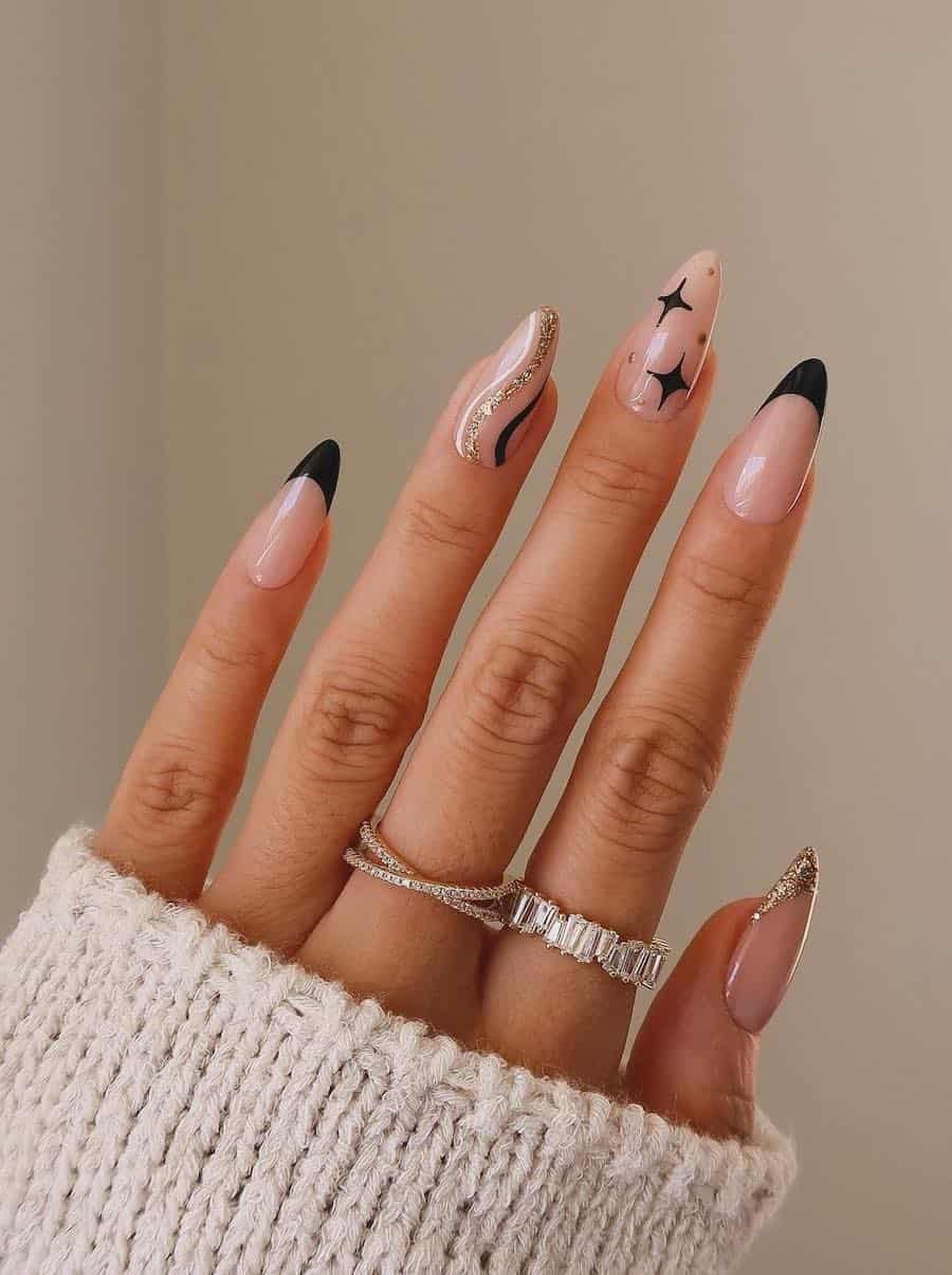 nude nails with black and gold holiday art and tips
