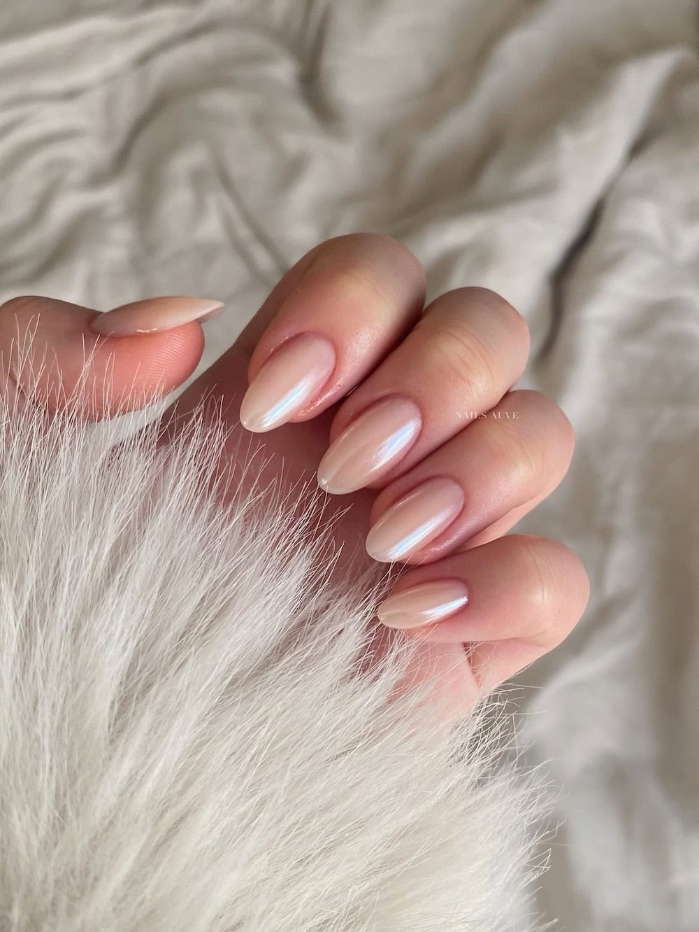 Short pearly almond nails in champagne polish