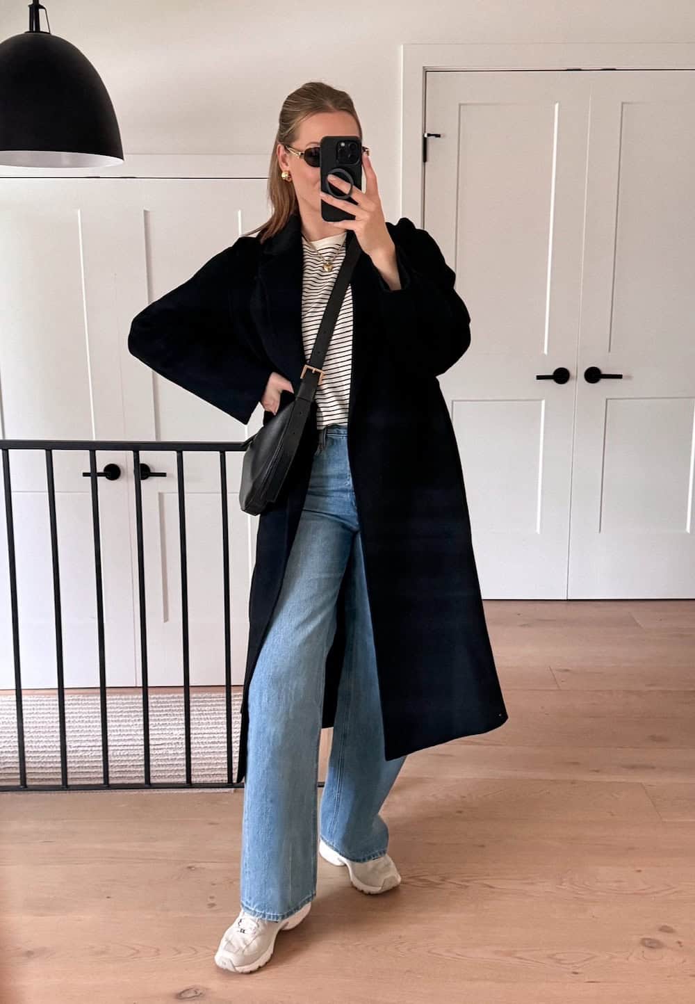 Christal wearing jeans with a striped tee and a duster cardigan with New Balance sneakers.