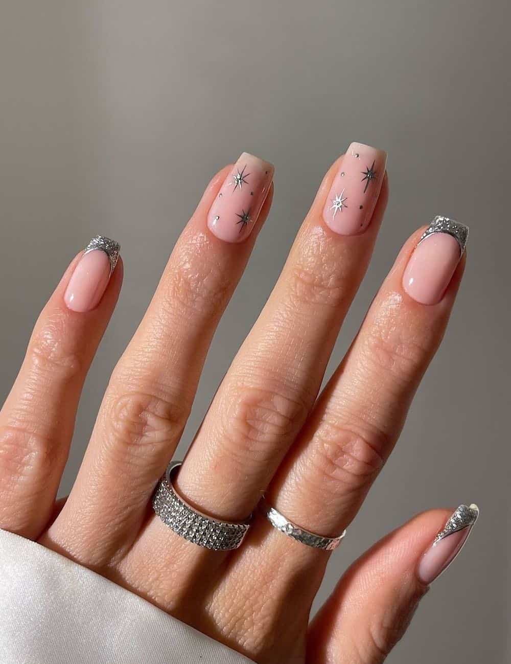 Short nude nails with silver tips and glitter