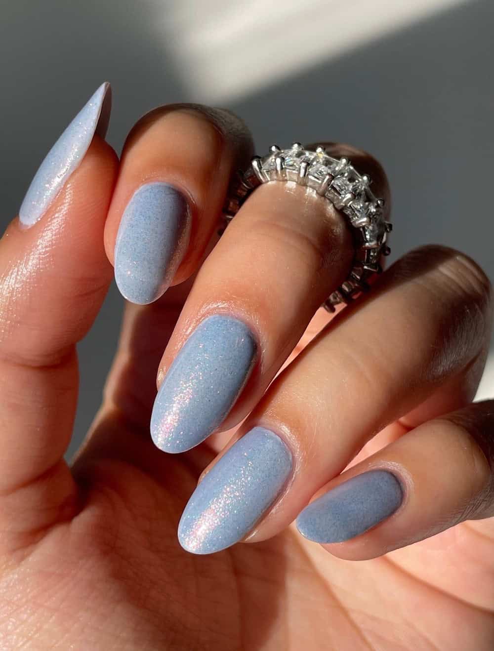 Long sparkling blue almond nails