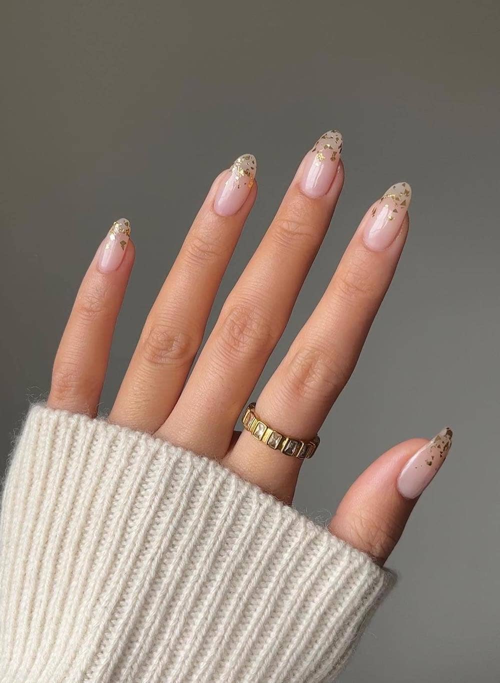 Long nude nails with gold foil tips