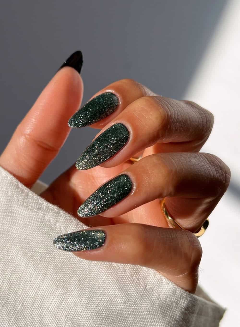 Long sparkling black almond nails