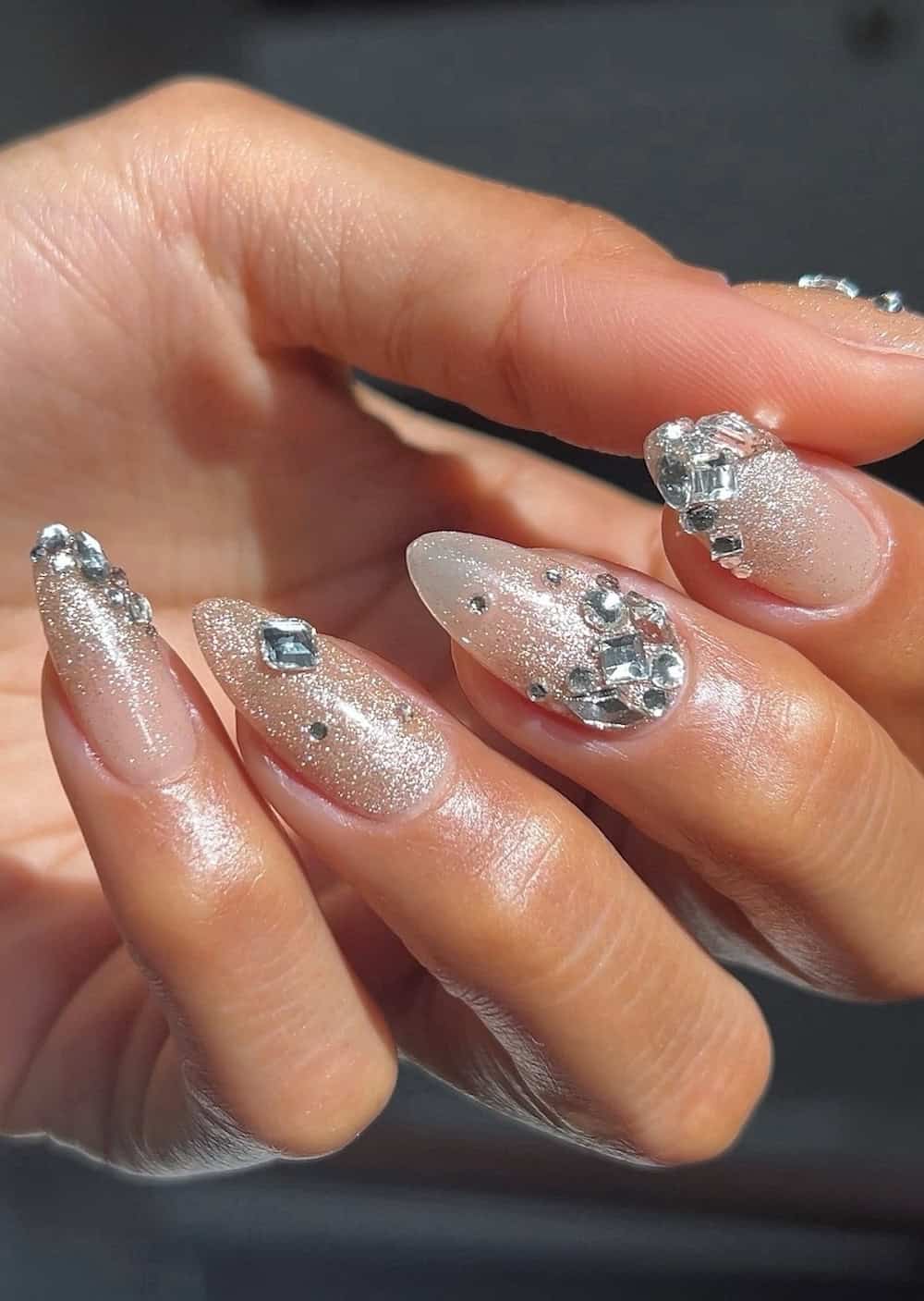 Long almond nails sparkling with crystals
