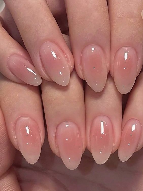 2. Graceful Simplicity with Glossy Nude Almond Nails