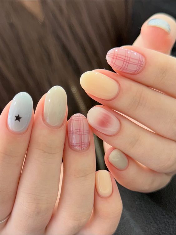 12. Playful Patterns and Subtle Elegance on Short Almond Nails